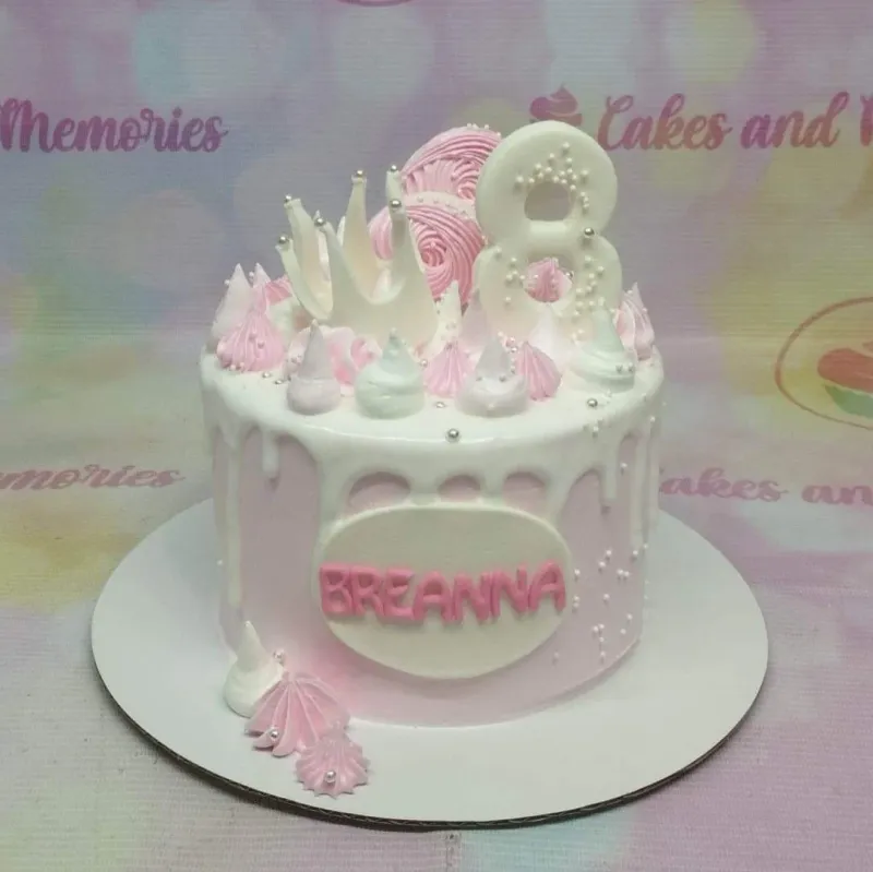 Pink 1-tier birthday cake with white drip, pink and white meringue kisses, a white number 8 topper, and a white crown. Pink 1-tier birthday cake with white drip, pink and white meringue kisses, a white number 8 topper, and a white crown.