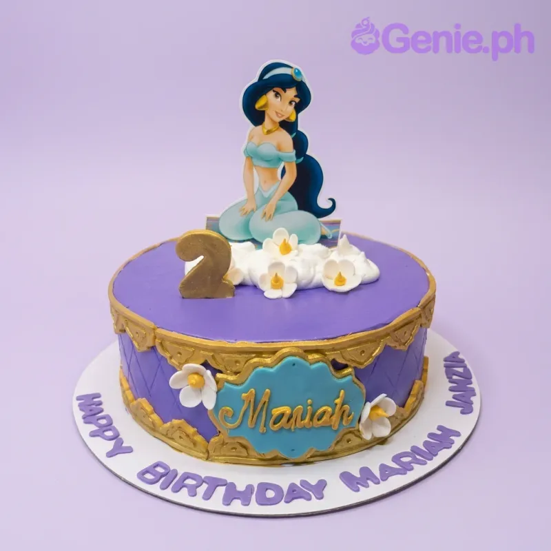A purple 1-tier Princess Jasmine cake with a Jasmine character topper, gold number 2 candle, gold filigree, and white flowers. A purple 1-tier Princess Jasmine cake with a Jasmine character topper, gold number 2 candle, gold filigree, and white flowers.