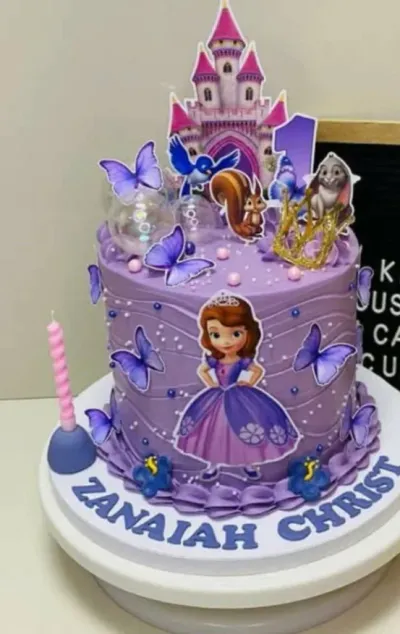 Purple 1-tier cake with soft icing, Princess Sofia Birthday theme, a character printout, and a gold plastic tiara Purple 1-tier cake with soft icing, Princess Sofia Birthday theme, a character printout, and a gold plastic tiara
