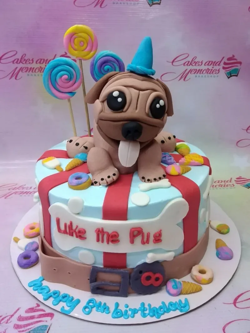 A colorful 1 Tier Fondant cake themed around Pug Dog, featuring pug figure, lollipops, and donuts. A colorful 1 Tier Fondant cake themed around Pug Dog, featuring pug figure, lollipops, and donuts.