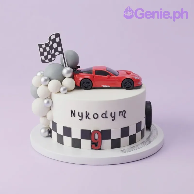 Ivory 1-tier fondant race car birthday cake with a red sports car topper, checkered band, and checkered flag Ivory 1-tier fondant race car birthday cake with a red sports car topper, checkered band, and checkered flag