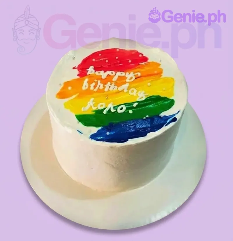A white and rainbow 1 Tier cake themed Rainbow Palette Knife, featuring rainbow icing strokes and a 'Happy Birthday Koko' message. A white and rainbow 1 Tier cake themed Rainbow Palette Knife, featuring rainbow icing strokes and a 'Happy Birthday Koko' message.
