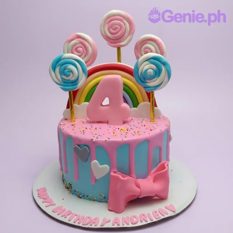 A blue and pink 1 Tier cake themed Rainbow Lollipop, featuring a pink '4', rainbow, and swirled lollipops, with a pink drip and sprinkles. A blue and pink 1 Tier cake themed Rainbow Lollipop, featuring a pink '4', rainbow, and swirled lollipops, with a pink drip and sprinkles.