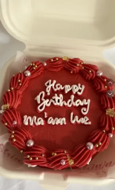 Bright red bento cake with smooth soft icing, a red piped rosette border, and silver pearl sprinkles Bright red bento cake with smooth soft icing, a red piped rosette border, and silver pearl sprinkles