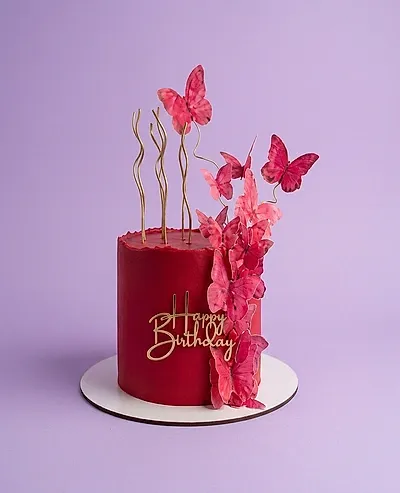 Dark red single tier cake with pink butterfly toppers and gold Happy Birthday message Dark red single tier cake with pink butterfly toppers and gold Happy Birthday message