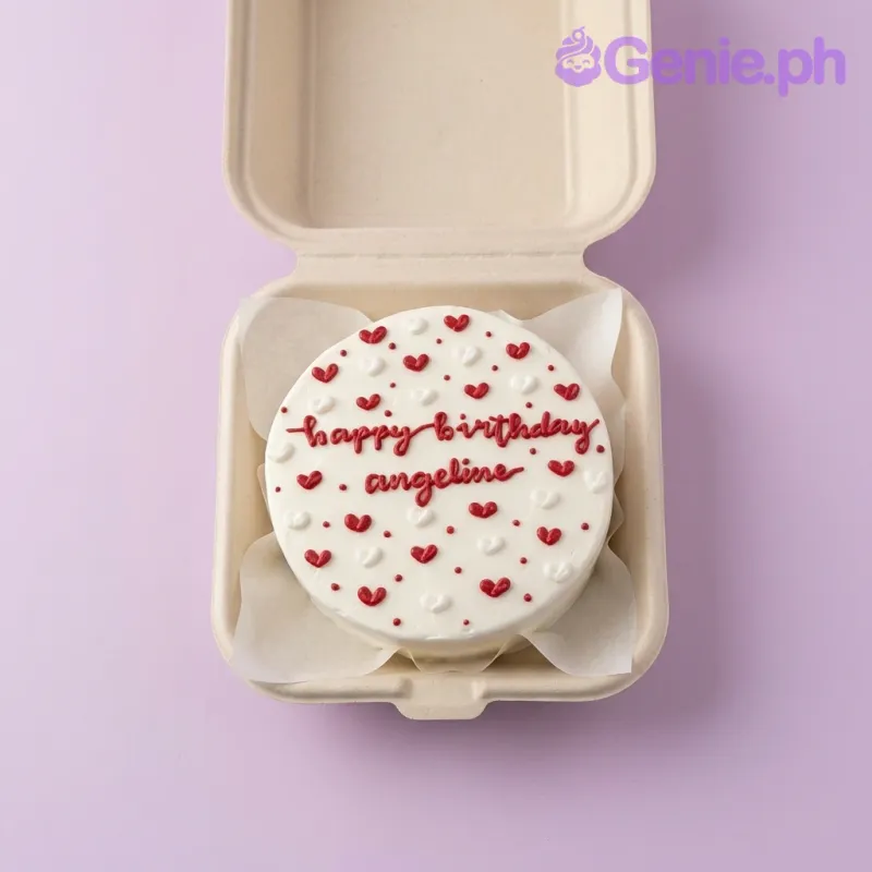 A white and red Bento cake themed around Red Heart Minimalist, featuring red and white piped icing hearts and a 'happy birthday' message. A white and red Bento cake themed around Red Heart Minimalist, featuring red and white piped icing hearts and a 'happy birthday' message.