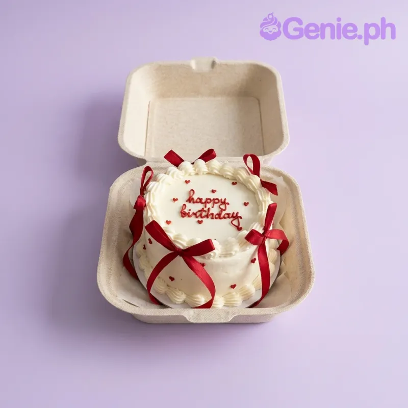 White bento cake with red satin ribbons and red piped Happy Birthday message White bento cake with red satin ribbons and red piped Happy Birthday message