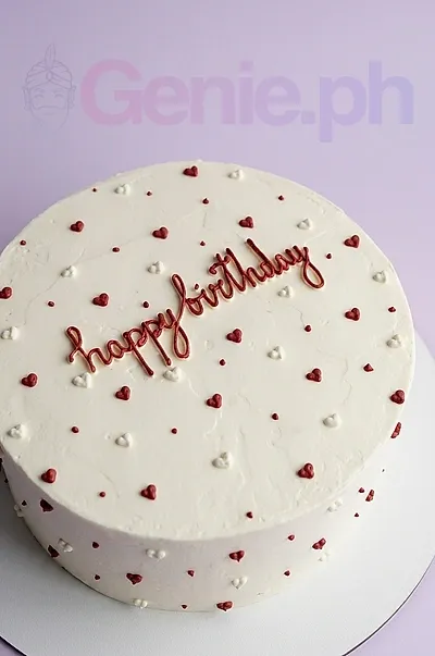 A white and red one-tier cake themed around Red Minimalist, featuring a "happy birthday" message and piped hearts. A white and red one-tier cake themed around Red Minimalist, featuring a "happy birthday" message and piped hearts.