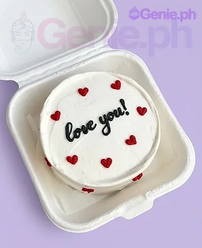 A white, red, and black bento cake themed Red Minimalist, featuring small red icing hearts and black 'love you!' text. A white, red, and black bento cake themed Red Minimalist, featuring small red icing hearts and black 'love you!' text.