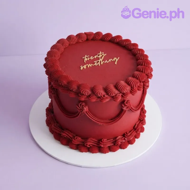 Dark red 1-tier vintage cake with soft icing, piped buttercream rosettes, and a gold script age topper Dark red 1-tier vintage cake with soft icing, piped buttercream rosettes, and a gold script age topper