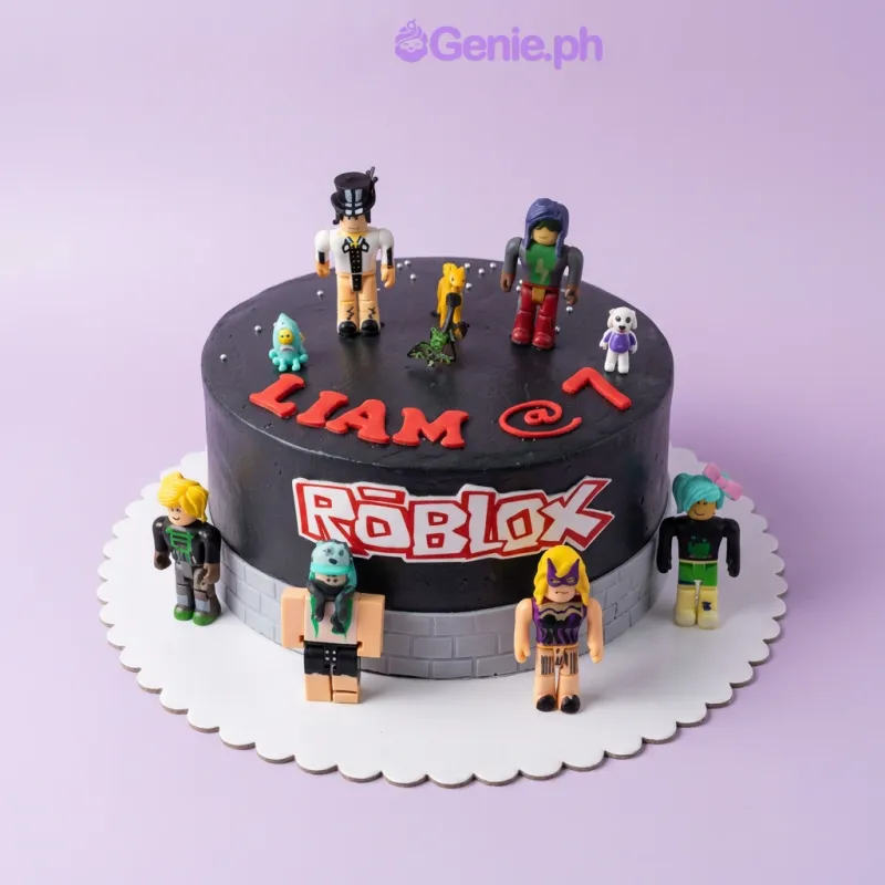 A black and red 1 Tier Roblox-themed cake, featuring Roblox figures, a logo, a grey brick panel, and 'LIAM @ 7' message. A black and red 1 Tier Roblox-themed cake, featuring Roblox figures, a logo, a grey brick panel, and 'LIAM @ 7' message.