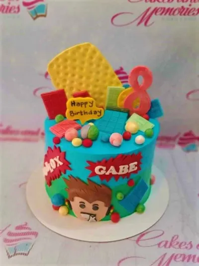 A blue and green 1 Tier cake themed around Roblox, featuring a character face, a red number 8 topper, and colorful blocks. A blue and green 1 Tier cake themed around Roblox, featuring a character face, a red number 8 topper, and colorful blocks.