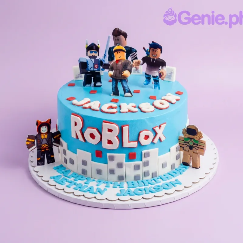 A blue and white 1 Tier cake themed around Roblox, featuring Roblox character printouts, a fondant city skyline, and personalized messages. A blue and white 1 Tier cake themed around Roblox, featuring Roblox character printouts, a fondant city skyline, and personalized messages.