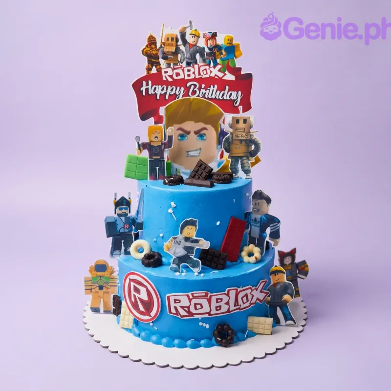 A blue 2-tier cake themed around Roblox, featuring character printouts, a Roblox logo, and chocolate bar decorations. A blue 2-tier cake themed around Roblox, featuring character printouts, a Roblox logo, and chocolate bar decorations.