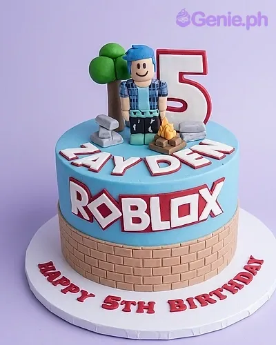 A blue Roblox 1-tier fondant cake, with a character, red number 5, brick wall base, and Roblox logo. A blue Roblox 1-tier fondant cake, with a character, red number 5, brick wall base, and Roblox logo.