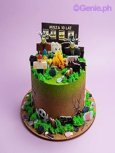 A green and brown 1 Tier cake themed around Roblox, featuring a campfire, message board, character printouts, and grass icing with game item cutouts. A green and brown 1 Tier cake themed around Roblox, featuring a campfire, message board, character printouts, and grass icing with game item cutouts.