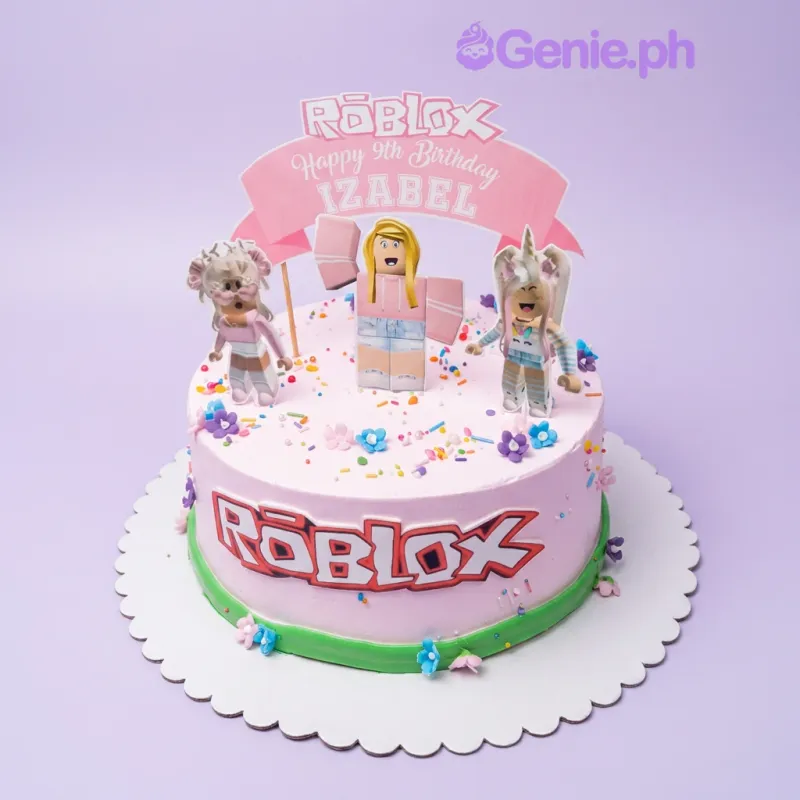 A pink, colorful 1 Tier Roblox cake, featuring Roblox girl characters, a Roblox logo banner, and 'Happy 9th Birthday IZABEL'. A pink, colorful 1 Tier Roblox cake, featuring Roblox girl characters, a Roblox logo banner, and 'Happy 9th Birthday IZABEL'.