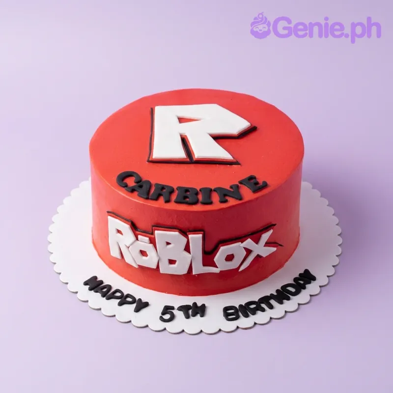 A red and white 1 Tier cake themed around Roblox, featuring a large white and black logo and 3D fondant letters. A red and white 1 Tier cake themed around Roblox, featuring a large white and black logo and 3D fondant letters.