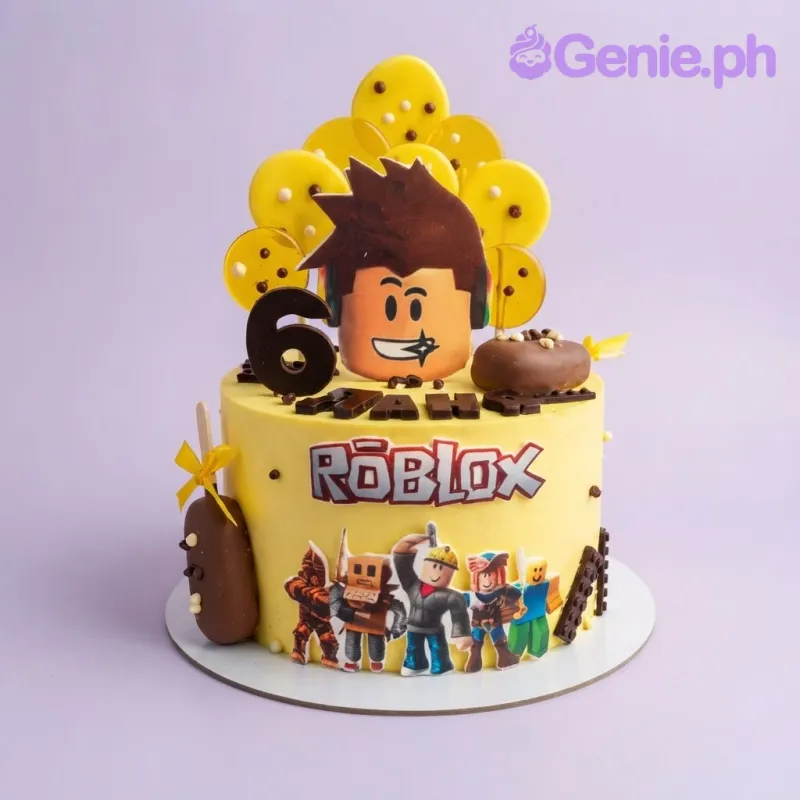 Vibrant yellow 1-tier Roblox theme birthday cake with printout character toppers, isomalt lollipops, and chocolate treats Vibrant yellow 1-tier Roblox theme birthday cake with printout character toppers, isomalt lollipops, and chocolate treats