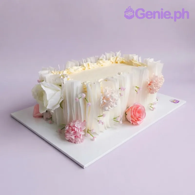 Ivory rectangle cake with smooth soft icing, romantic floral theme, and white fondant roses Ivory rectangle cake with smooth soft icing, romantic floral theme, and white fondant roses