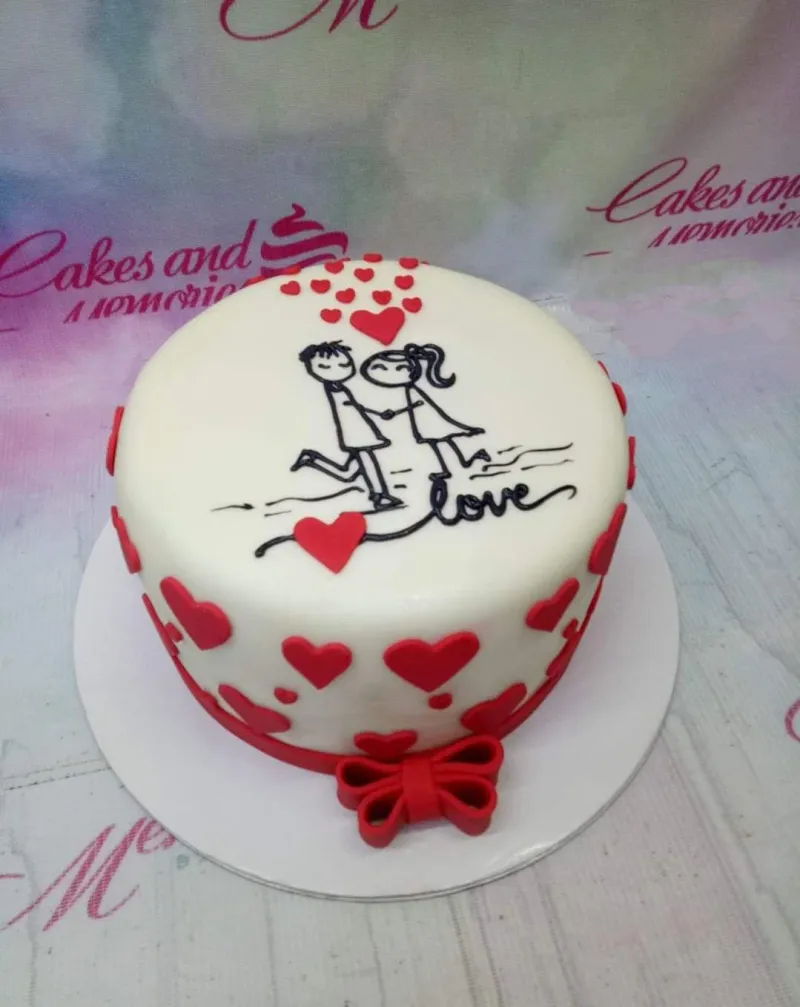 A white 1 Tier Fondant Romantic Love cake, with a hand-drawn couple illustration, red hearts, a red bow, and a 'love' message. A white 1 Tier Fondant Romantic Love cake, with a hand-drawn couple illustration, red hearts, a red bow, and a 'love' message.