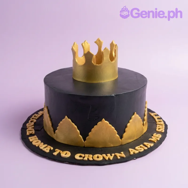 A black and gold 1 Tier Fondant cake themed Royal Crown, featuring a gold crown topper, gold leaf accents, and gold board text. A black and gold 1 Tier Fondant cake themed Royal Crown, featuring a gold crown topper, gold leaf accents, and gold board text.
