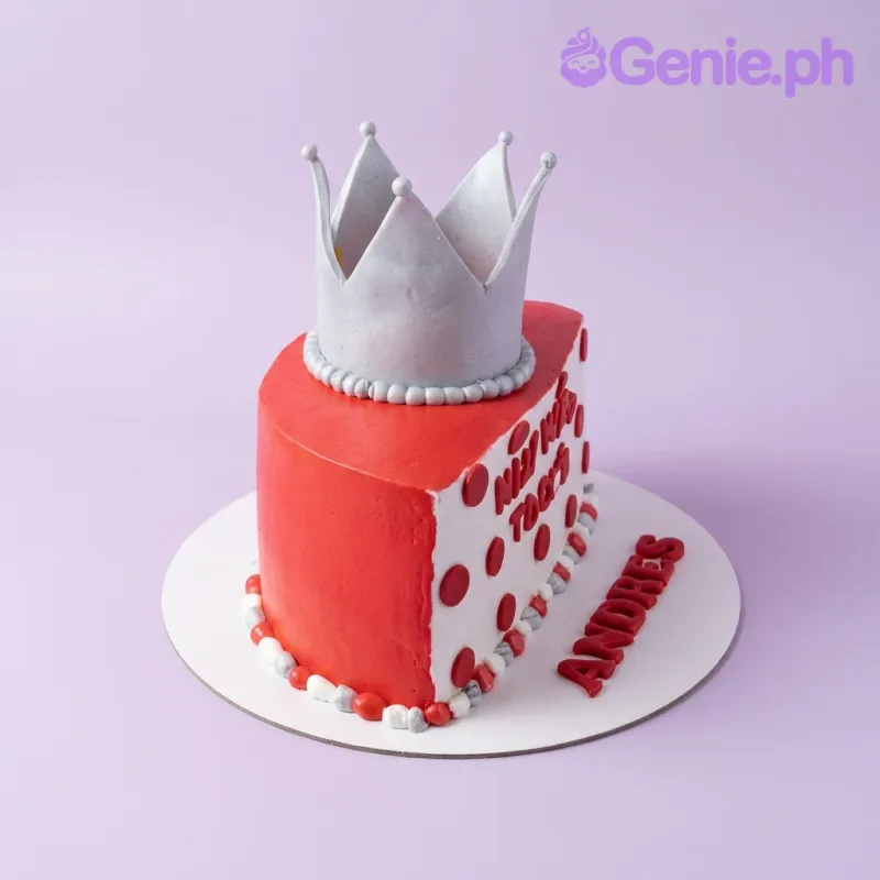 Red and white heart-shaped crown cake with silver toy crown and red gumpaste letters on the base board. Red and white heart-shaped crown cake with silver toy crown and red gumpaste letters on the base board.