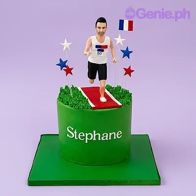Green 1-tier fondant cake with a male runner figurine, a French flag printout, and red running track detail on top Green 1-tier fondant cake with a male runner figurine, a French flag printout, and red running track detail on top