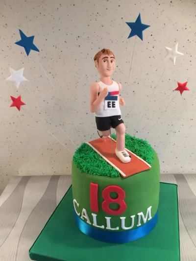 Green fondant cake with a runner figurine topper, running track, and star decorations Green fondant cake with a runner figurine topper, running track, and star decorations