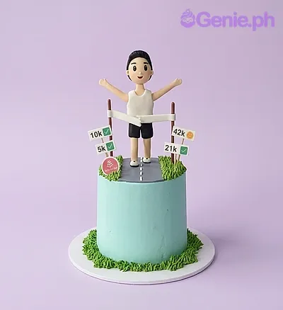 Light blue 1-tier cake with a runner figurine, printed race distance signs, a fondant road panel, and piped grass borders Light blue 1-tier cake with a runner figurine, printed race distance signs, a fondant road panel, and piped grass borders