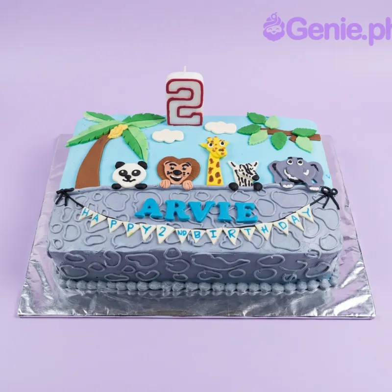 A blue rectangle Safari Animal cake, featuring a number 2 candle, fondant safari animals, palm tree, and clouds. A blue rectangle Safari Animal cake, featuring a number 2 candle, fondant safari animals, palm tree, and clouds.