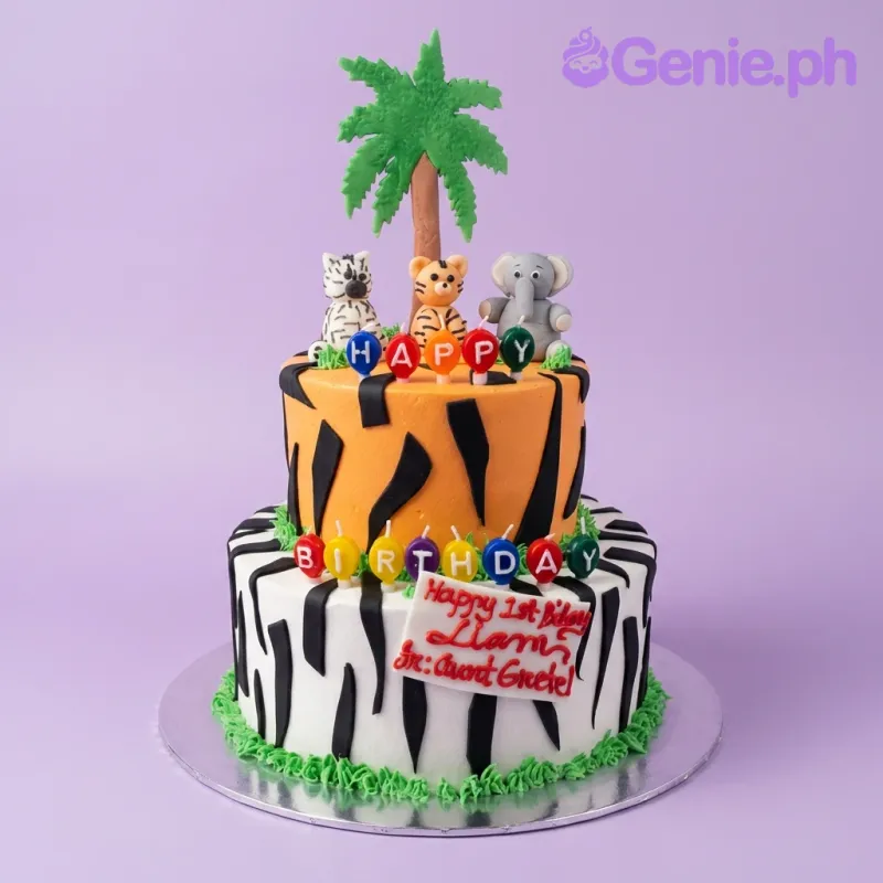 A multi-colored two-tier cake themed Safari Animals, featuring fondant elephant, tiger, and zebra figures, accented with animal stripes. A multi-colored two-tier cake themed Safari Animals, featuring fondant elephant, tiger, and zebra figures, accented with animal stripes.