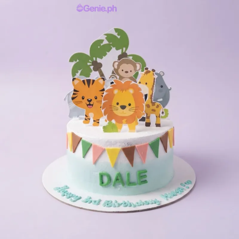 A white and light blue 1-tier cake themed around Safari Animals, featuring lion, tiger, giraffe, and monkey toppers and colorful bunting flags. A white and light blue 1-tier cake themed around Safari Animals, featuring lion, tiger, giraffe, and monkey toppers and colorful bunting flags.