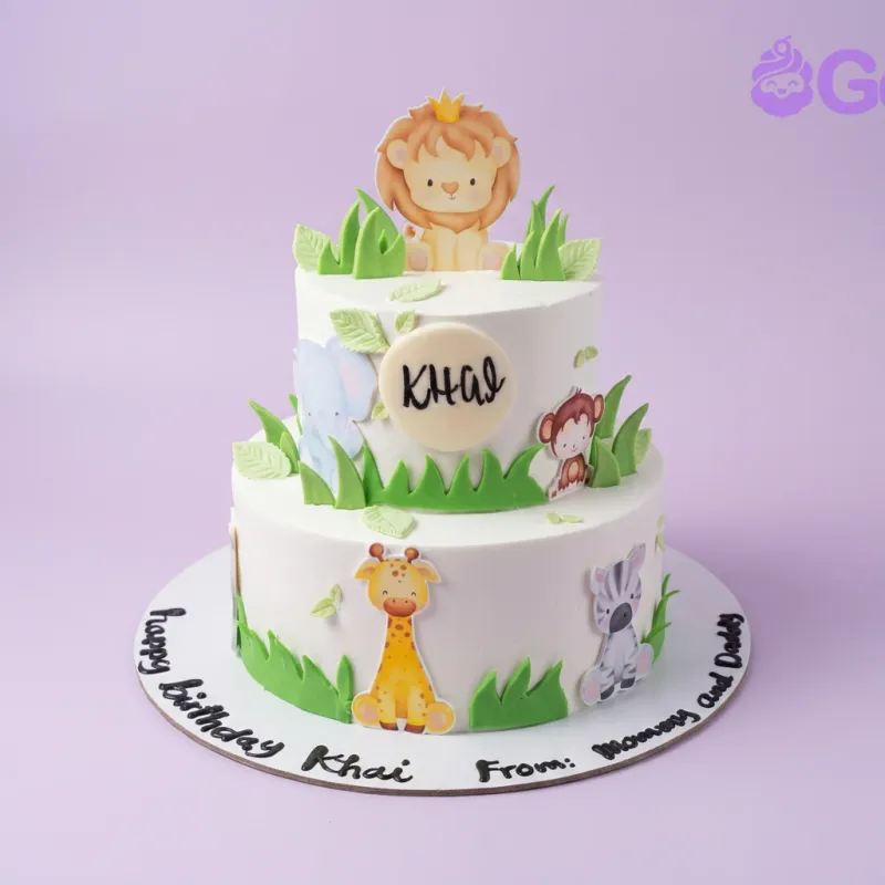 A white and green two-tier Safari Animal cake, with various animal printouts and green fondant grass. A white and green two-tier Safari Animal cake, with various animal printouts and green fondant grass.