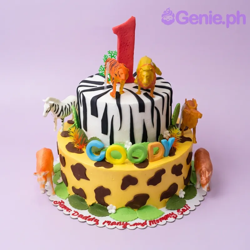 Multicolor 2 Tier Fondant Safari Animal cake, with zebra and giraffe patterns, toy animals, a red number one. Multicolor 2 Tier Fondant Safari Animal cake, with zebra and giraffe patterns, toy animals, a red number one.