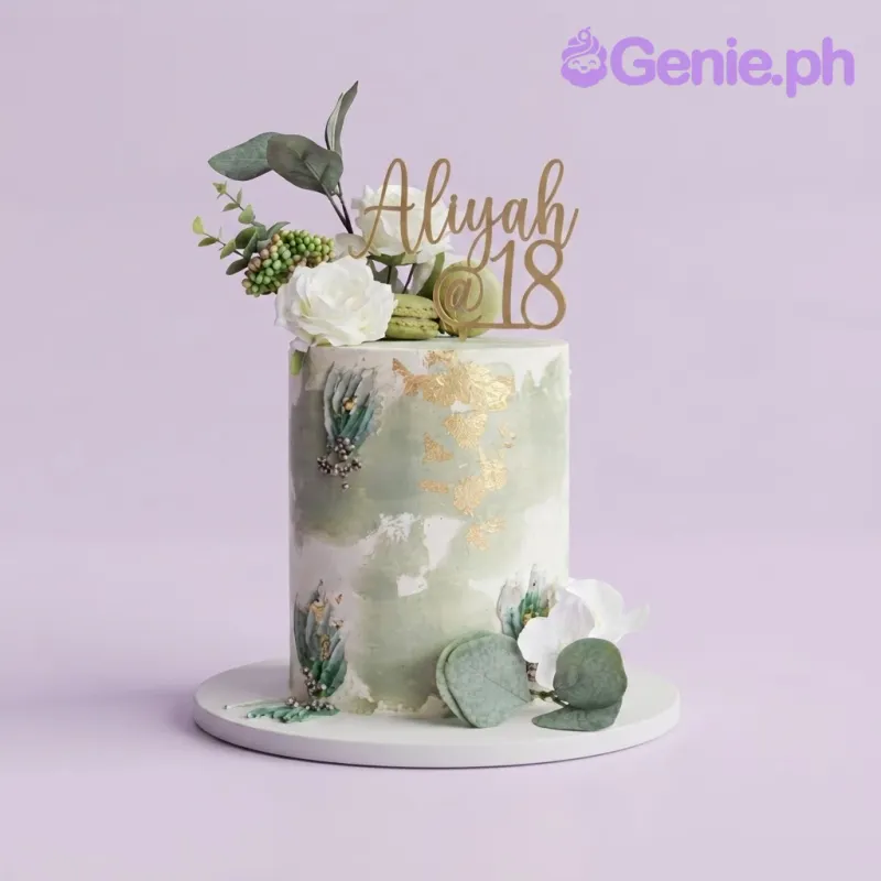 Sage green 1-tier soft icing birthday cake with gold leaf flakes, floral arrangement, and gold acrylic topper Sage green 1-tier soft icing birthday cake with gold leaf flakes, floral arrangement, and gold acrylic topper