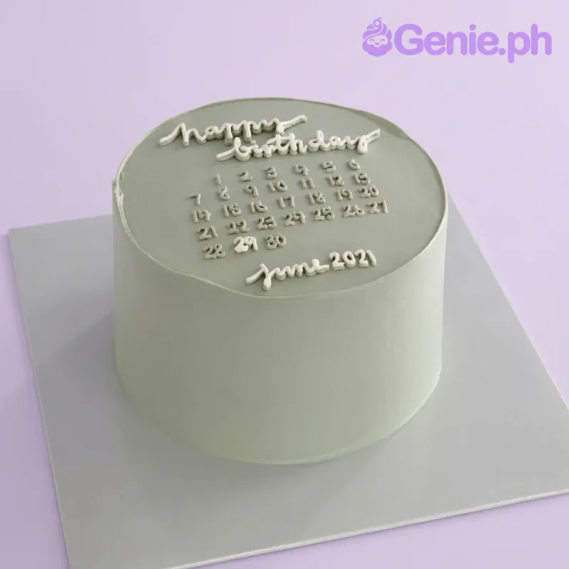 A sage green and white 1-tier cake themed around a calendar, featuring white icing numbers for June 2021 and a 'happy birthday' message. A sage green and white 1-tier cake themed around a calendar, featuring white icing numbers for June 2021 and a 'happy birthday' message.