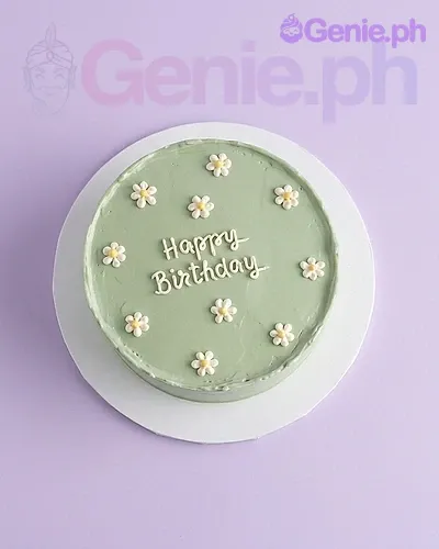 A sage green 1 Tier cake themed Sage Green Daisy, featuring piped white daisies with yellow centers and 'Happy Birthday' text. A sage green 1 Tier cake themed Sage Green Daisy, featuring piped white daisies with yellow centers and 'Happy Birthday' text.