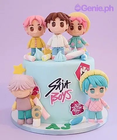 A light blue fondant cake, Saja Boys Kpop theme, with five 3D boy figurines, marshmallows, and 'Saja Boys' text. A light blue fondant cake, Saja Boys Kpop theme, with five 3D boy figurines, marshmallows, and 'Saja Boys' text.