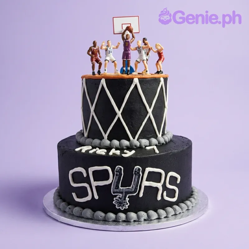 Black 2-tier basketball cake with San Antonio Spurs logo and basketball player figurines on top Black 2-tier basketball cake with San Antonio Spurs logo and basketball player figurines on top