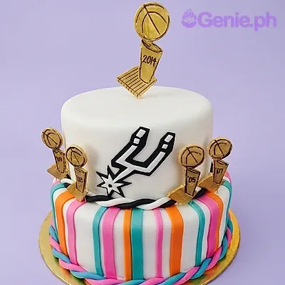 White 2-tier fondant cake with San Antonio Spurs logo and five gold basketball trophy printouts White 2-tier fondant cake with San Antonio Spurs logo and five gold basketball trophy printouts