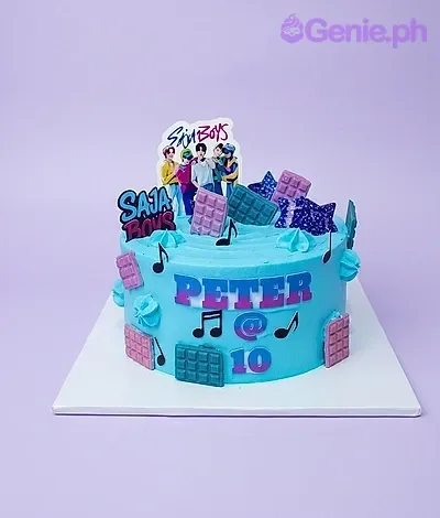 A blue 1-tier cake themed SB19 K-pop, featuring an SB19 group photo, Saja Boys logo, chocolate bars, music notes, and 'PETER @ 10'. A blue 1-tier cake themed SB19 K-pop, featuring an SB19 group photo, Saja Boys logo, chocolate bars, music notes, and 'PETER @ 10'.