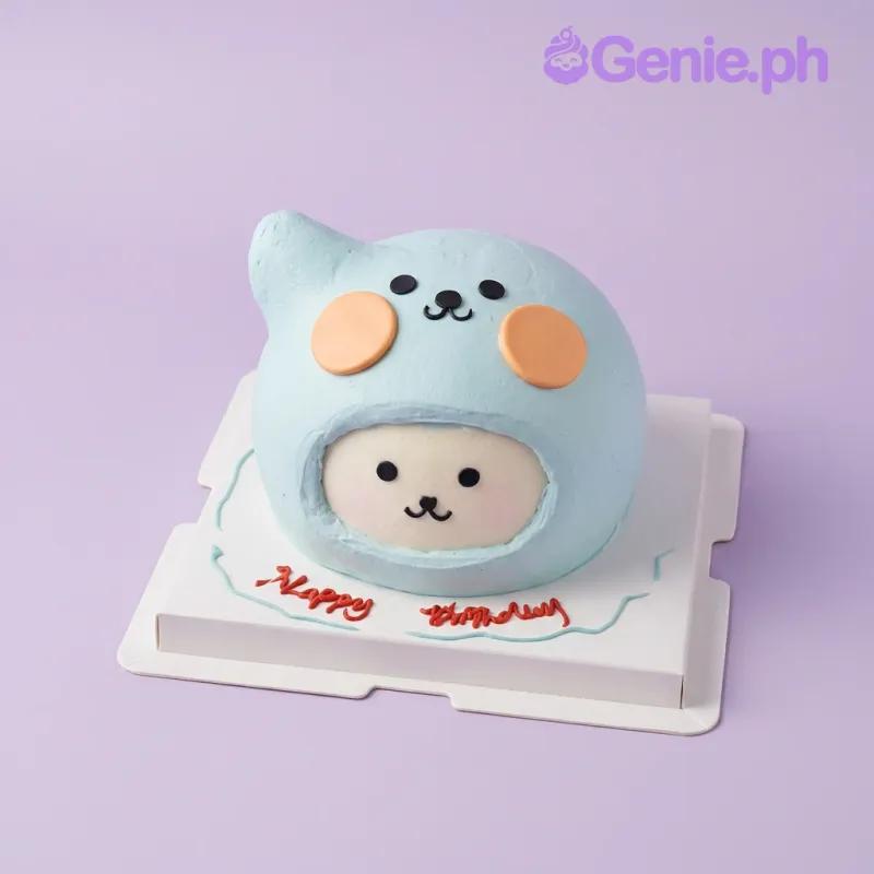 One tier cake with sky blue soft icing, black icing eyes, nose, mouth, and orange icing cheeks One tier cake with sky blue soft icing, black icing eyes, nose, mouth, and orange icing cheeks
