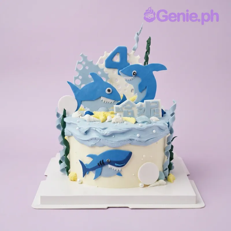 Light blue and white 1-tier birthday cake with Baby Shark printout toppers and fondant seashells Light blue and white 1-tier birthday cake with Baby Shark printout toppers and fondant seashells