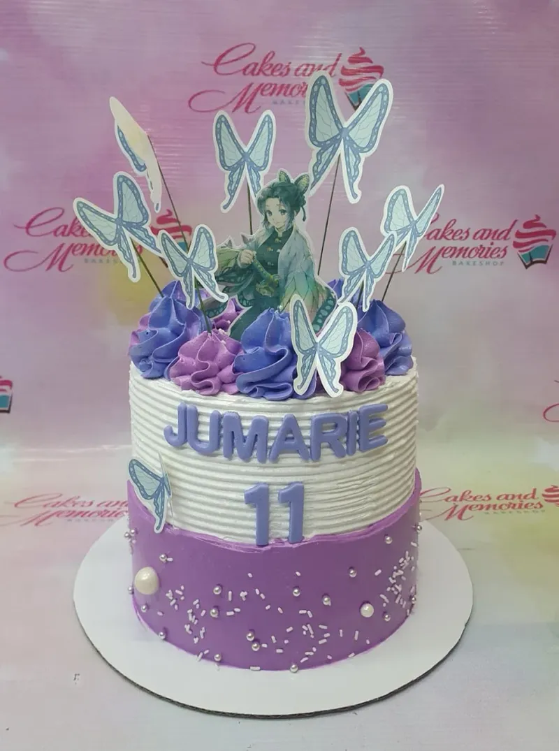 A purple and white 1-Tier Shinobu Kocho cake, with a character topper, butterfly printouts, and silver sprinkles. A purple and white 1-Tier Shinobu Kocho cake, with a character topper, butterfly printouts, and silver sprinkles.