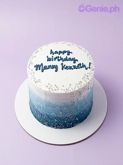 A white and blue 1 Tier cake themed around a silver birthday, featuring silver sprinkles and blue text. A white and blue 1 Tier cake themed around a silver birthday, featuring silver sprinkles and blue text.