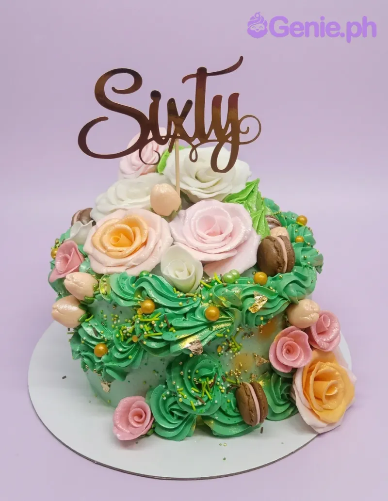 A green, pink, peach 1 Tier 60th birthday cake, with a rose gold 'Sixty' topper and floral sugar roses. A green, pink, peach 1 Tier 60th birthday cake, with a rose gold 'Sixty' topper and floral sugar roses.