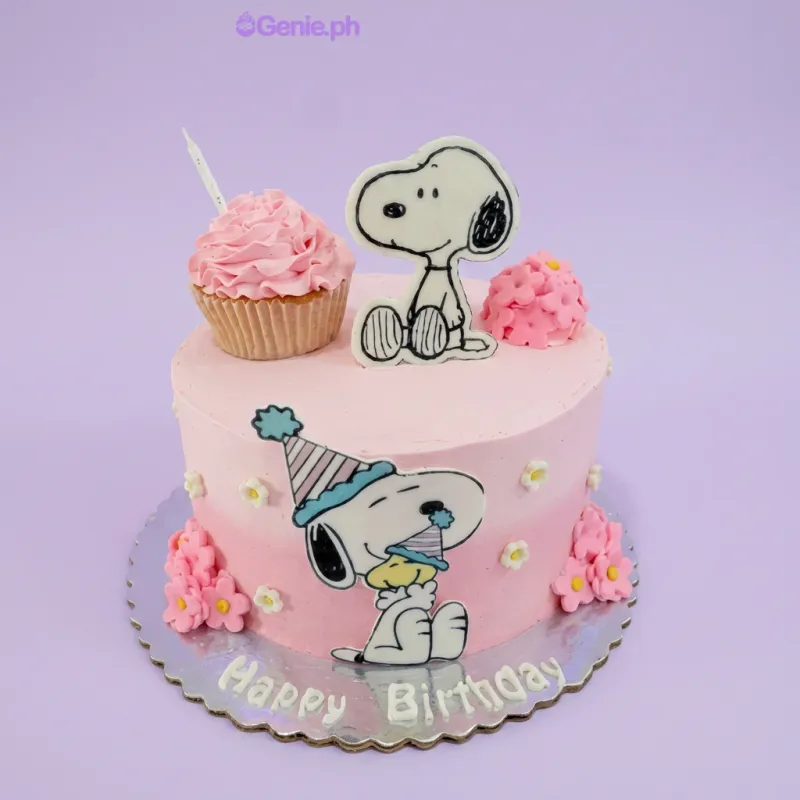 Snoopy Birthday cake design — 1 layer soft icing cake in pink — with Snoopy character printout, Snoopy character printout, cupcake, birthday candle, and custom "Happy Birthday" message Snoopy Birthday cake design — 1 layer soft icing cake in pink — with Snoopy character printout, Snoopy character printout, cupcake, birthday candle, and custom "Happy Birthday" message