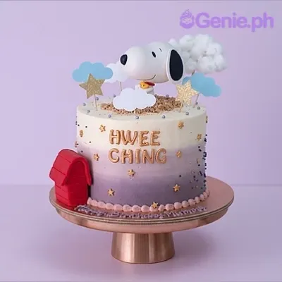 Ombre purple and white 1-tier birthday cake with Snoopy figurine and red doghouse topper Ombre purple and white 1-tier birthday cake with Snoopy figurine and red doghouse topper