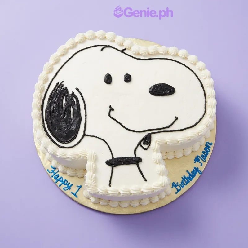 One tier Snoopy cake with white soft icing and piped facial features One tier Snoopy cake with white soft icing and piped facial features